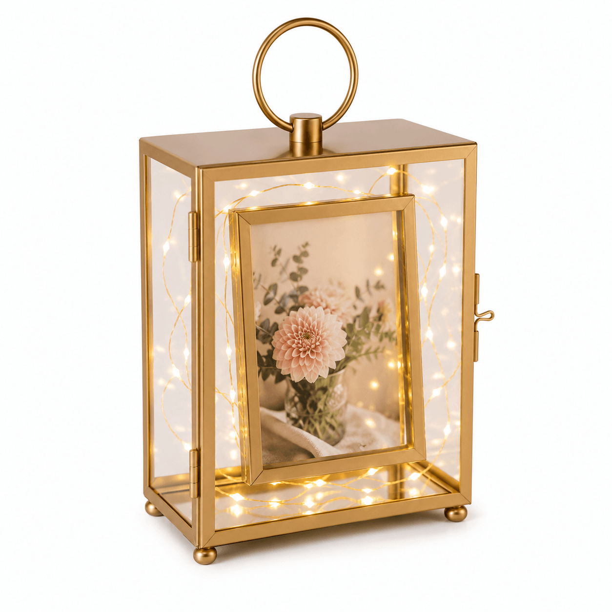 Gold lantern with fairy lights and a floral photo inside on a white background