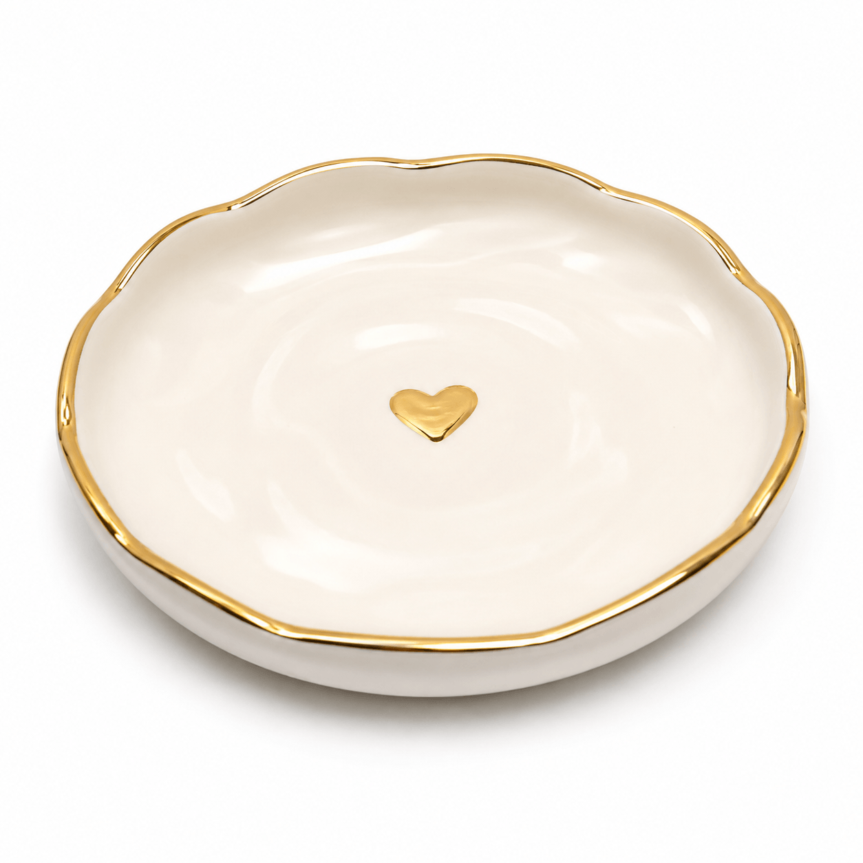 White dish with gold rim and heart-shaped gold emblem on a white background