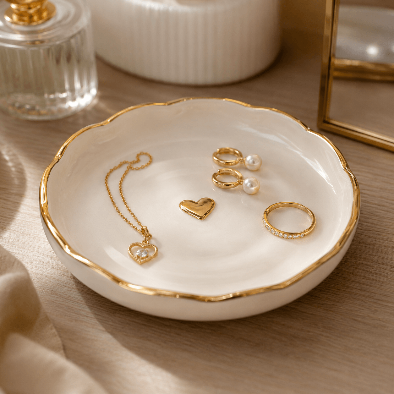Jewelry set including a necklace, heart-shaped pendant, and rings on a decorative dish with gold rim.